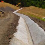 Concrete canvas along a channel for erosion protection