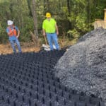 Construction works using angular rock to backfill baselok geocells for permanent erosion control