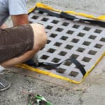 A professional checking the EconoSack after heavy rainfall to prevent ponding