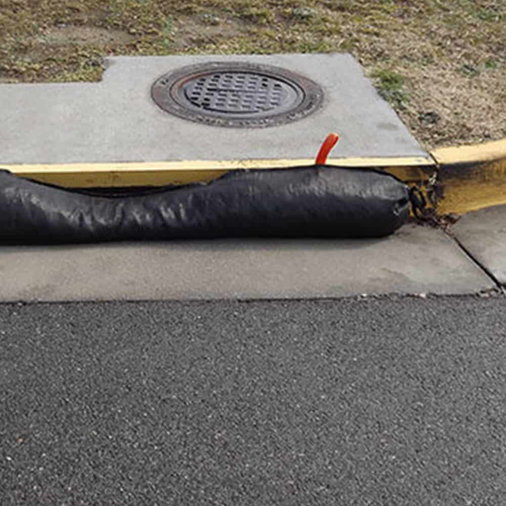 A GutterEEL placed in front of a roadside drain in order to prevent contamination from nearby jobsite