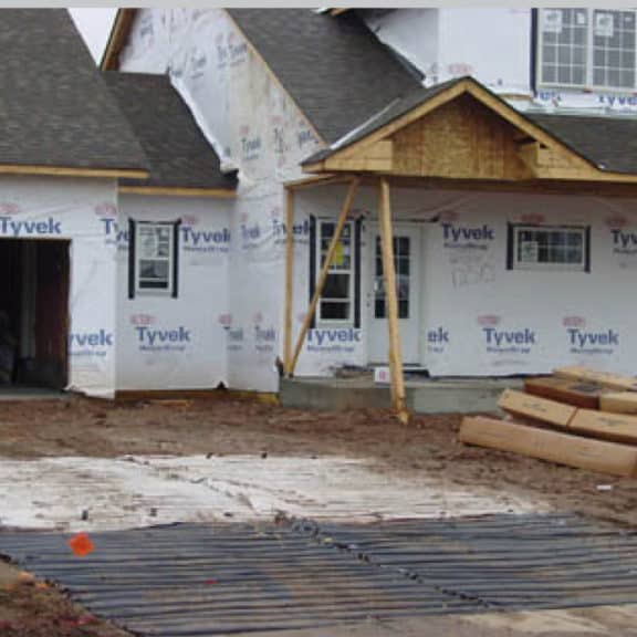 Mud mats protecting the front yard of a residential home that is being built