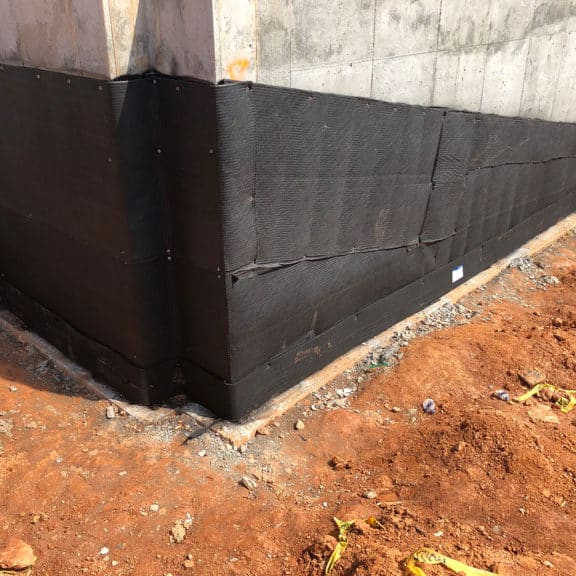 black water proofing material lining the bottom portion of a cement structure