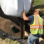 A city construction worker installing a FocalPoint Biofiltration System