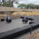 Stormwater management professionals constructing a modular underground storage tank