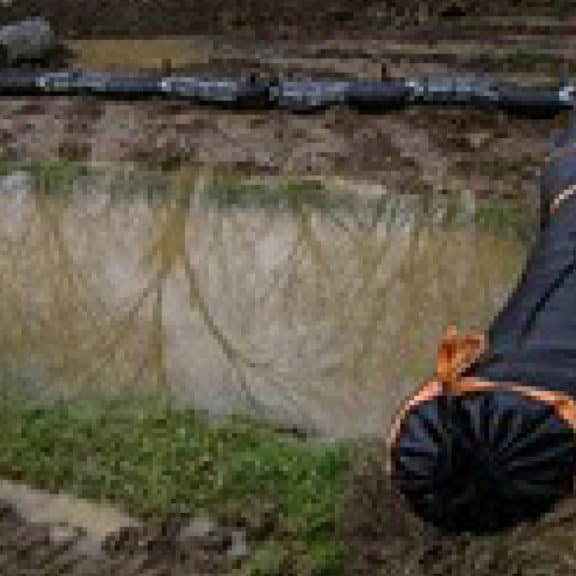 A reusable erosion eel surrounding a low point on a job site to prevent localized flooding