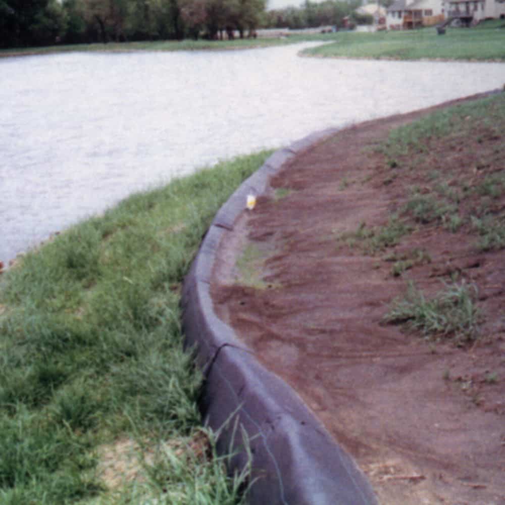 A reusable & lightweight triangular silt dike barrier between a body of water and land