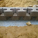 Cement blocks reinforced with 4" geogrid for slope and wall stabilization