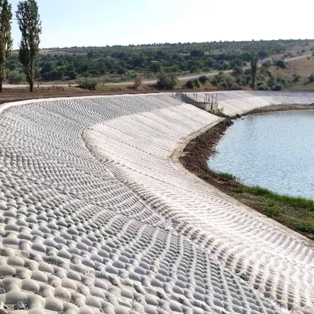 A concrete mattress system, Incomat Hard Armor, surrounding a man-made spillway