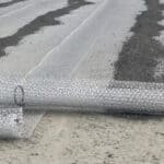A high-strength geotextile being installed at a container yard for superior ground stabilization.